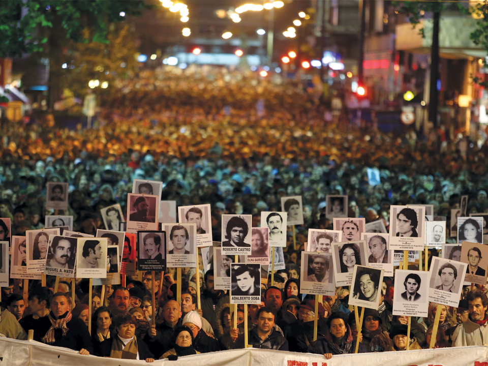 Uruguayans at the annual March of Silence, displaying photographs of relatives believed to have been kidnapped by military forces during the dictatorship (1973-1985).
