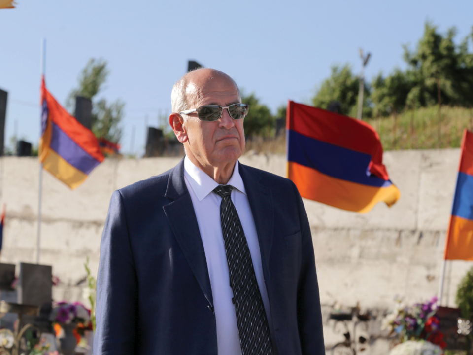Berge Setrakian at Yerablur Martyrs Pantheon paying his respects with Armenian flags surrounding him.