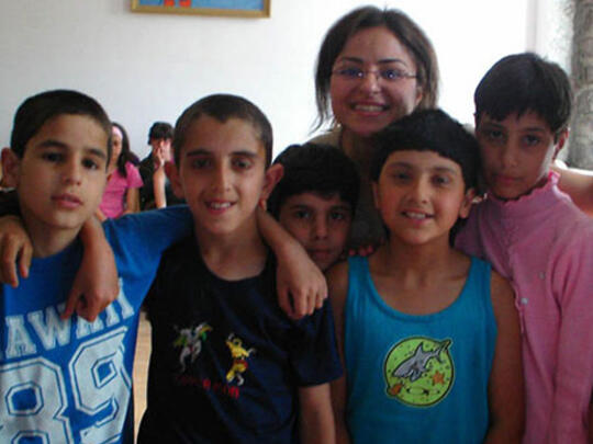 A YP Yerevan member brings cheer, clothing, and toys to chil