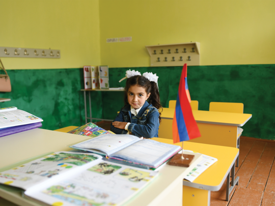 Liana, a first grade student from Kalavan, Armenia inside her classroom.