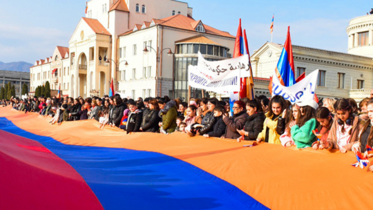 Protestors with Armenian flag fighting Artsakh blockade 